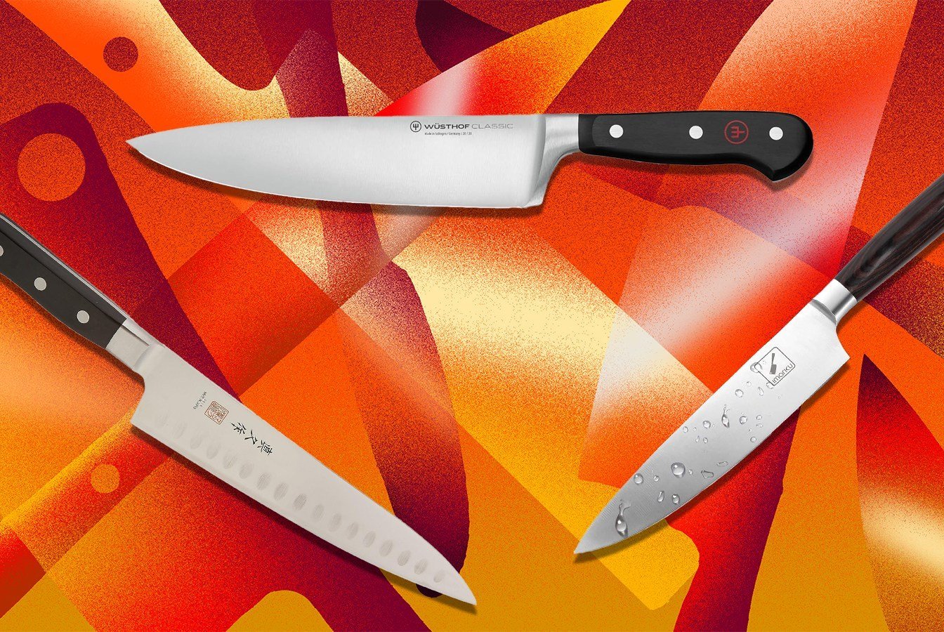 A selection of professional kitchen knives resting on a wooden board.
