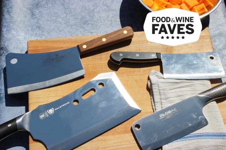 A sharp professional cleaver knife rests on a wooden board with fresh ingredients.