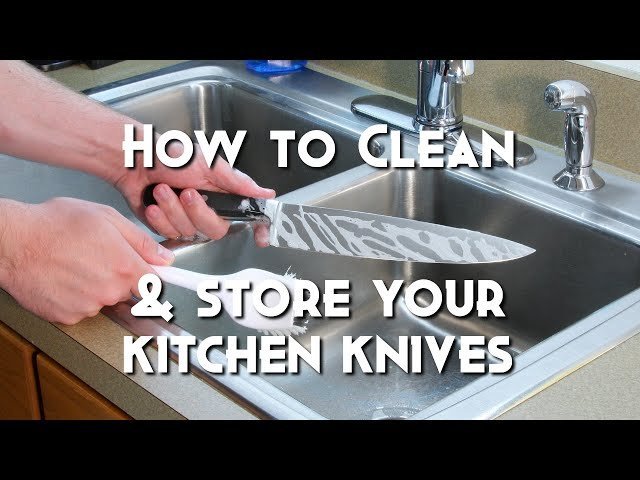 Inspecting a clean kitchen knife to ensure no residue remains on the blade.