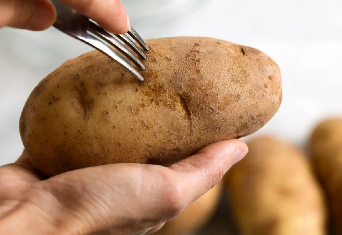 Piercing potatoes with a fork